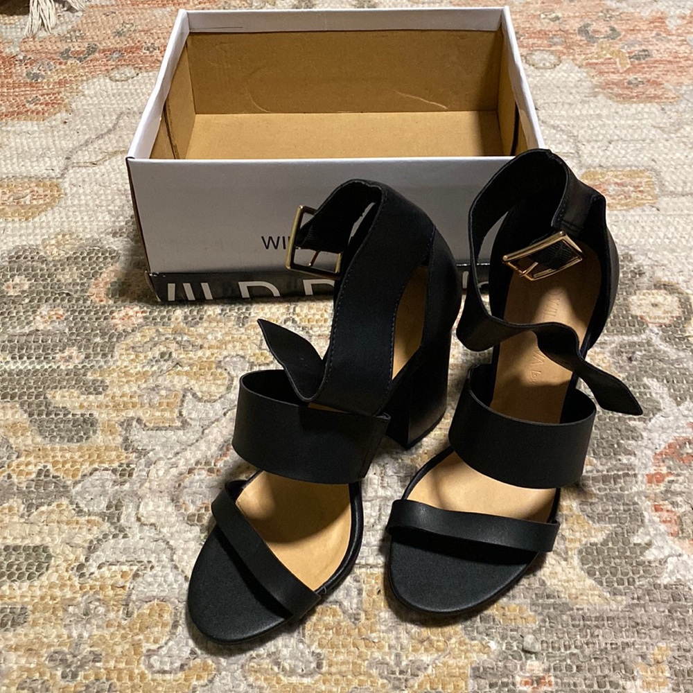Black strapped heels with gold buckle
